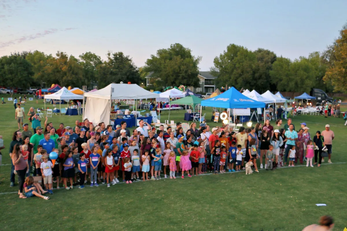 A wide group photo of Davis community members at Family Fun Fest