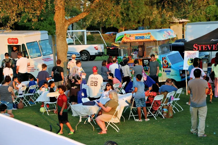Food trucks lined up in golden evening light at Family Fun Fest