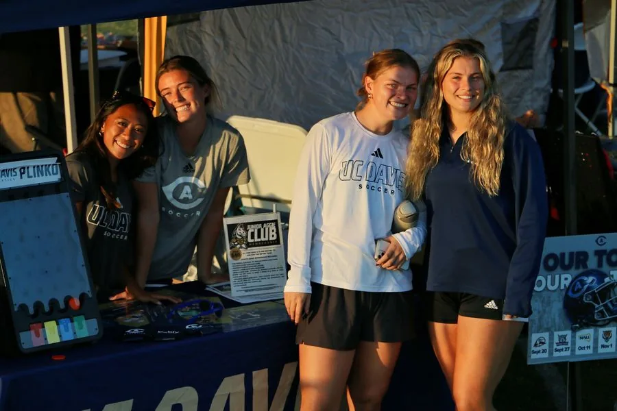 UC Davis soccer players at the Davis Community Soccer booth at Family Fun Fest