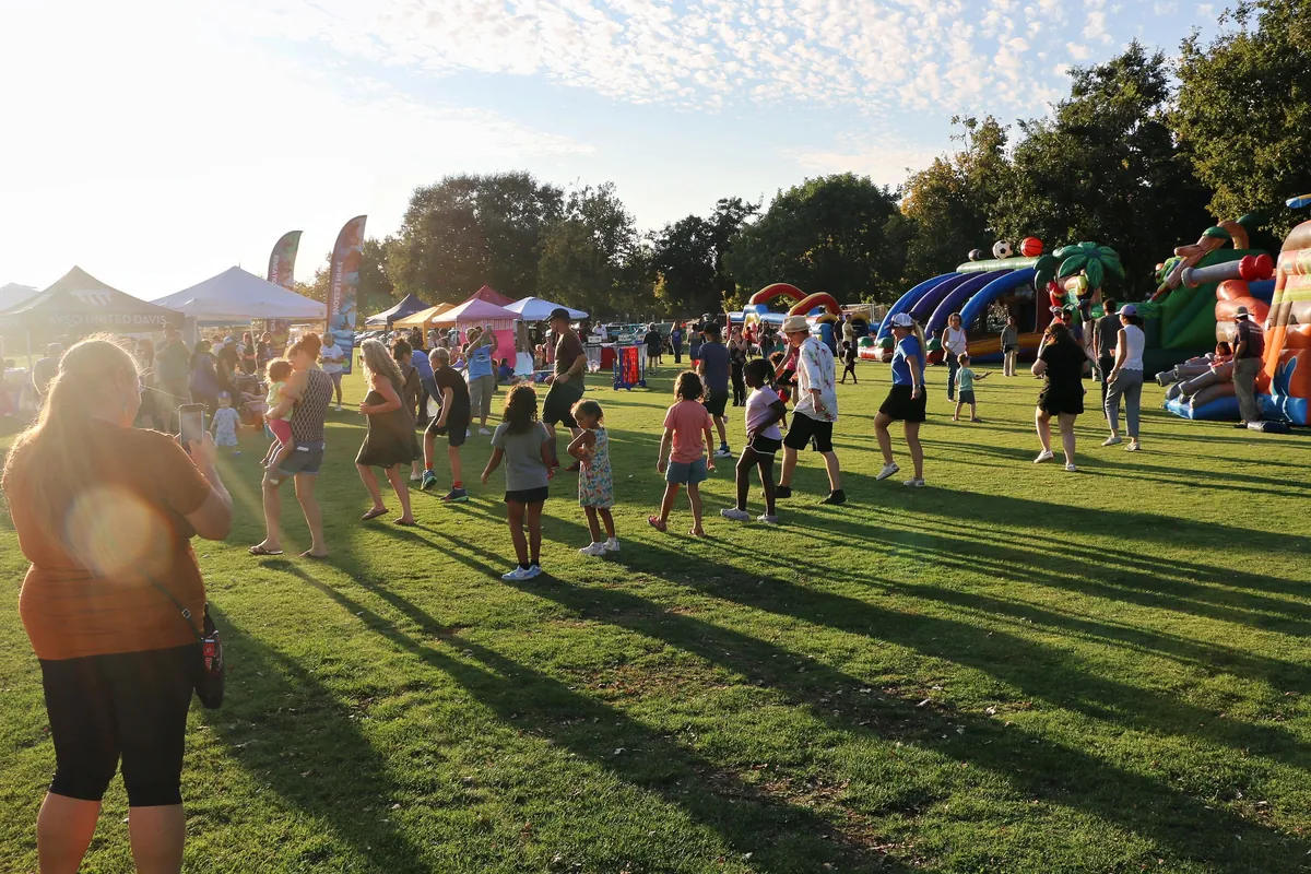 Davis neighbors gathered together in golden evening light at a Chamber event